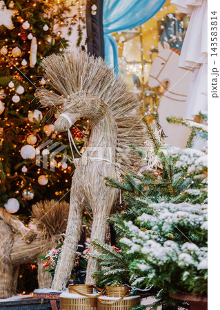 Christmas tree and traditional reindeer decoration made of natural straw on festive light background 143583814