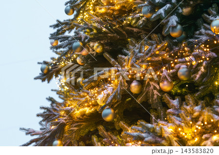 Christmas tree decorated with gold and silver ornaments and warm glowing string lights close up, Christmas tree decorated with gold and silver ornaments and warm glowing string lights close up, 143583820