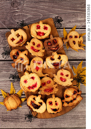 Scary ghost cookies,ghosts and pumpkins on old concrete background,cafe advertisement and menu,restaurant business card,Halloween food concept,idea for cooking holiday dishes for kids and adults. 143583868