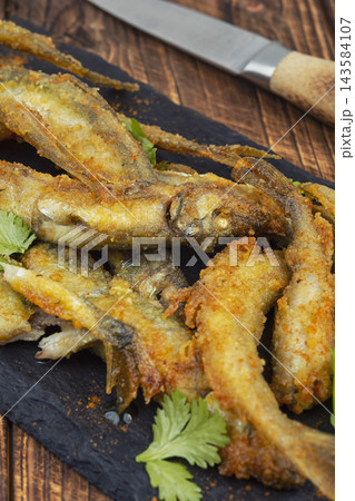Homemade crispy capelin fish with lemon. Homemade crispy capelin fish with lemon. 143584107