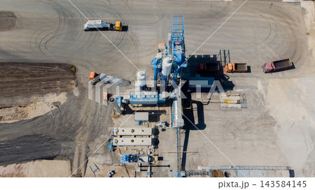 Construction site with machinery and equipment in operation during the day Construction site with machinery and equipment in operation during the day 143584145