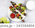 Roasted Eggplant, Zucchini and Tomato Kebabs 143584804