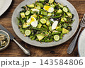 Green asparagus salad with avocado, cucumber and soft boiled egg 143584806