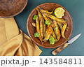 Traditional breaded capelin with lemon wedges 143584811