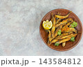 Crispy Small Fried Fish with Parsley and Lemon 143584812