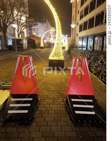 Orange anti-ram blocks in the pedestrian zone with festive illuminations 143585037