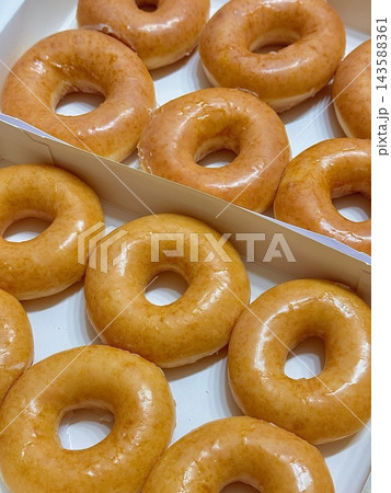 A classic glazed donut with a soft, fluffy texture and a sweet, glossy coating. Perfectly balanced between light and sugary, making it an irresistible treat for any time of the day. 143588361