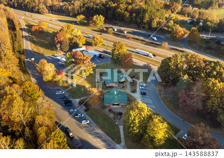Roadside parking area for cars and trucks on multilane interstate highway, serving as convenient stop for travelers on long drives. Roadside parking area for cars and trucks on multilane interstate highway, serving as convenient stop for travelers on long drives. 143588837