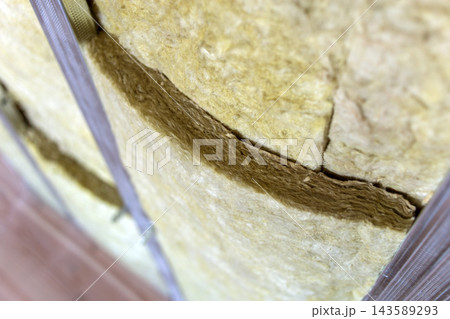 Wall of a room under renovation with mineral rock wool insulation and metal frame prepared for drywall plates. Wall of a room under renovation with mineral rock wool insulation and metal frame prepared for drywall plates. 143589293