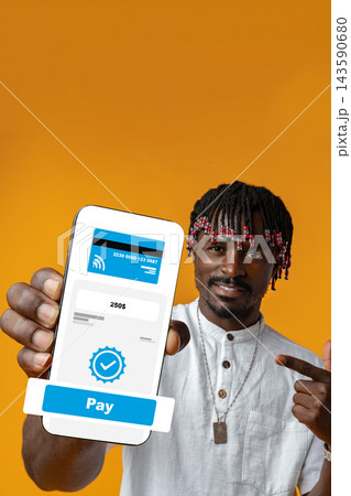 User showing a mobile payment screen and pointing at it in front of an orange background 143590680