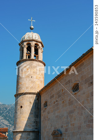 Church bell tower under clear sky near mountains 143590853
