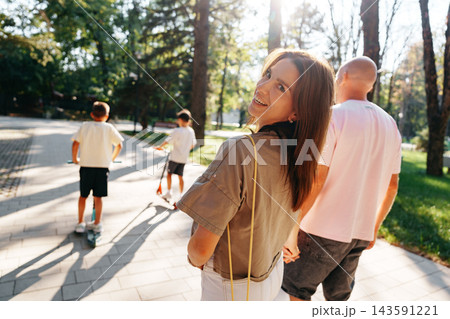 Family stroll in the park during afternoon with kids and adults enjoying time together 143591221