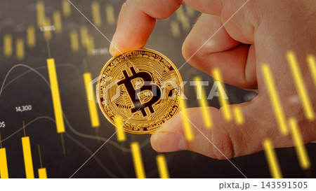 Visual representation of cryptocurrency with bitcoin being held in hand amid financial charts Visual representation of cryptocurrency with bitcoin being held in hand amid financial charts 143591505