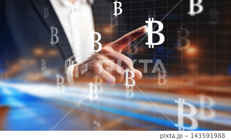 Touching a bitcoin symbol on a digital screen during a financial event 143591988