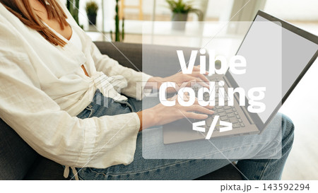 Vibe coding is happening in a cozy indoor space with a person working on a laptop Vibe coding is happening in a cozy indoor space with a person working on a laptop 143592294