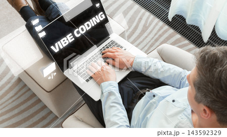 Person using a laptop to code and work on vibe coding at home in a relaxed setting Person using a laptop to code and work on vibe coding at home in a relaxed setting 143592329