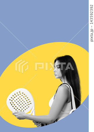 Young woman holds paddle in front of bright colored backdrop while preparing for a game 143592392