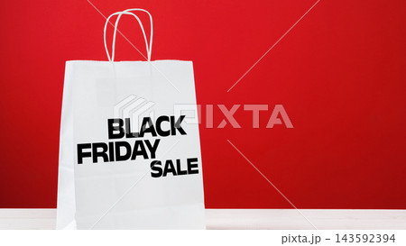 Black Friday sale bag displayed against a red background 143592394
