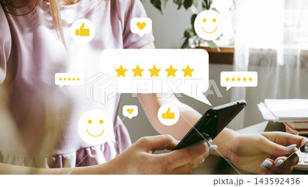 User reviews with five-star rating display on smartphone in a bright room User reviews with five-star rating display on smartphone in a bright room 143592436