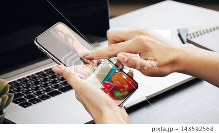 Engaging in social media chats and calls with a smartphone and laptop 143592568