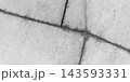 Cracked Concrete Pavement Surface with Damp Fissure Lines 143593331
