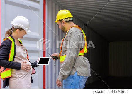 Pregnant female logistics supervisor using digital tablet with warehouse loading worker man at cargo shipping container yard 143593696