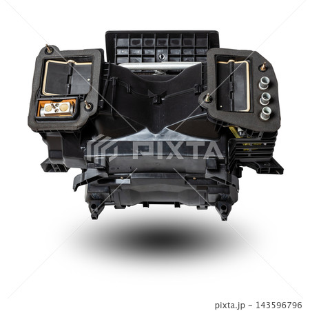 The body of the stove heater made of black plastic with an air conditioning system for repair and replacement on a car in a workshop on a white isolated background. Catalog of spare parts for 143596796
