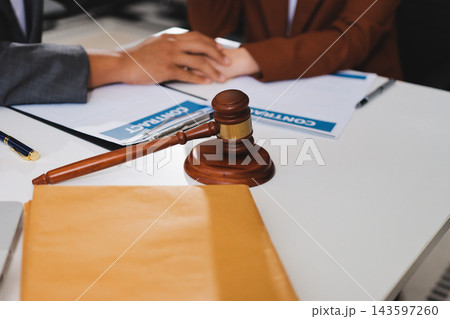 Businessmen or lawyers working together at a meeting, teamwork and partnership. Signing documents, contracts, checking details business agreement Businessmen or lawyers working together at a meeting, teamwork and partnership. Signing documents, contracts, checking details business agreement 143597260