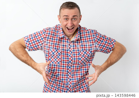 Adult male standing against a white background, wearing a checkered shirt, having an open mouth and animated expression, confidently gesturing with hands Adult male standing against a white background, wearing a checkered shirt, having an open mouth and animated expression, confidently gesturing with hands 143598446