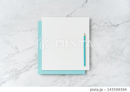 Top view of blank white and blue square greeting card with pencil mockup on marble background with copy space Top view of blank white and blue square greeting card with pencil mockup on marble background with copy space 143599394