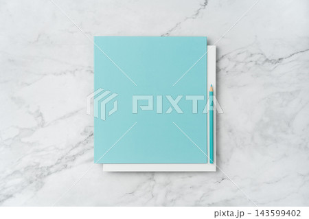 Top view of blank white and blue square greeting card with pencil mockup on marble background with copy space Top view of blank white and blue square greeting card with pencil mockup on marble background with copy space 143599402