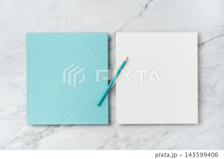 Top view of blank blue and white square greeting card with color pencil mockup on marble background with copy space Top view of blank blue and white square greeting card with color pencil mockup on marble background with copy space 143599406