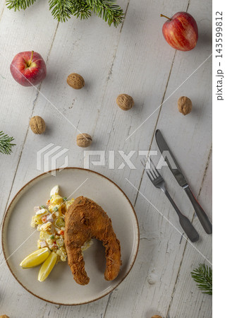 Fried carp with potato salad for Czech Christmas dinner 143599812
