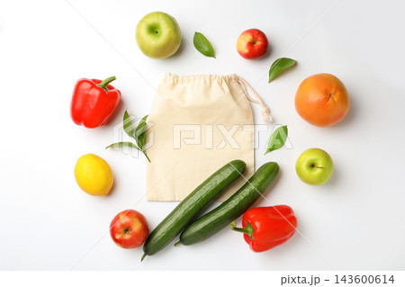 Cotton eco bag, fruits and vegetables on white background, top view Cotton eco bag, fruits and vegetables on white background, top view 143600614