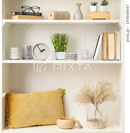 White shelving unit with plants and different decorative stuff White shelving unit with plants and different decorative stuff 143600647