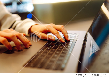 Close-up of hands working on a laptop keyboard. Young woman using laptop computer. Freelance Close-up of hands working on a laptop keyboard. Young woman using laptop computer. Freelance 143601533