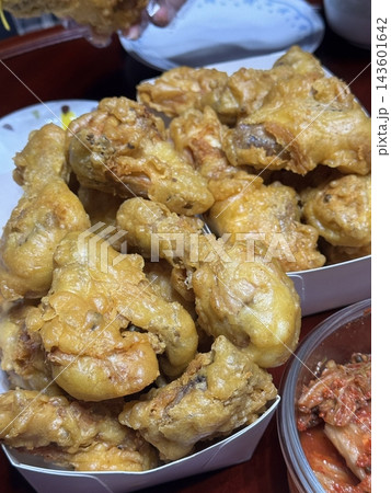 Crispy Korean fried chicken, perfectly glazed with a sweet and spicy sauce. Ideal for food photography and menus, showcasing the irresistible crunch and flavor of this beloved dish. Crispy Korean fried chicken, perfectly glazed with a sweet and spicy sauce. Ideal for food photography and menus, showcasing the irresistible crunch and flavor of this beloved dish. 143601642