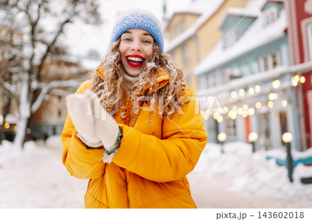 A young tourist enjoys a sunny winter day. The concept of holiday, relaxation. 143602018