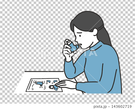 A female patient checks how to use the inhaler while looking at the instruction manual and then uses it. A female patient checks how to use the inhaler while looking at the instruction manual and then uses it. 143602719