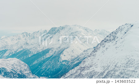 Panoramic snow-covered Caucasus mountain range with Mount Cheget rising above glaciated slopes and deep valleys ) 143603522