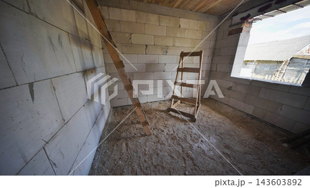 Unfinished room with wooden ladder and trestle during house construction process Unfinished room with wooden ladder and trestle during house construction process 143603892