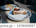 Slice of delicious cake with fresh blueberries on a plate in a cafe 143604887