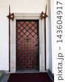 Vertical shot of an ancient medieval door with iron grille 143604917