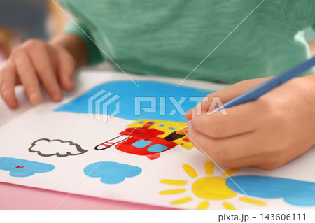 Little child painting at table, closeup view 143606111