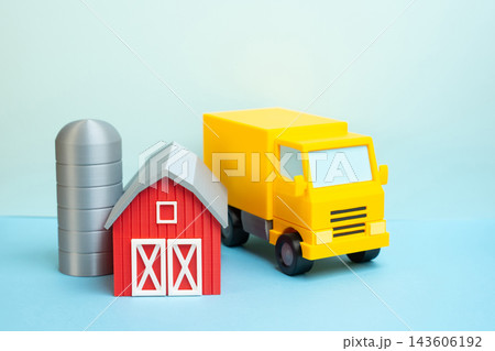 A delivery truck and a farm barn. Concept of farm to table supply chain and fresh food distribution logistics. Freshness delivered. Delivering agricultural produce to consumers. A delivery truck and a farm barn. Concept of farm to table supply chain and fresh food distribution logistics. Freshness delivered. Delivering agricultural produce to consumers. 143606192