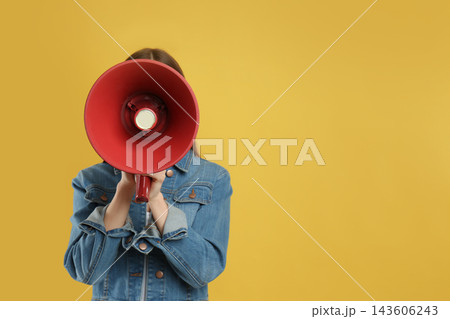 Young woman with megaphone on yellow background. Space for text Young woman with megaphone on yellow background. Space for text 143606243