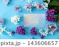 Purple lilac flowers with blank card on blue background 143606657