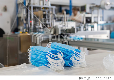 Stacks of medical face masks in a manufacturing facility Stacks of medical face masks in a manufacturing facility 143606737