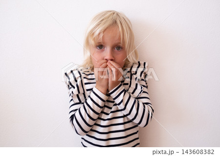 Hopeful Little Blonde Girl Holding Clasped Hands and Pleading Hopeful Little Blonde Girl Holding Clasped Hands and Pleading 143608382