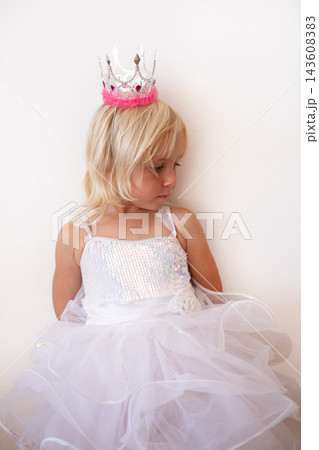 Little Blonde Girl Wearing Princess Crown and Dress Looking Down Little Blonde Girl Wearing Princess Crown and Dress Looking Down 143608383